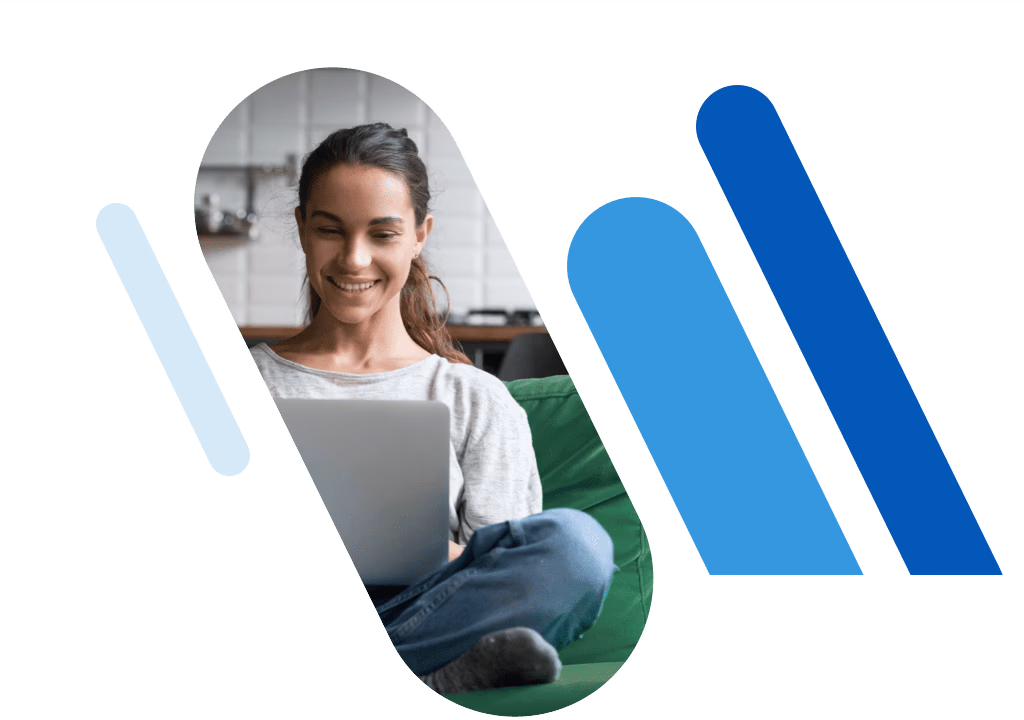Woman sitting on a couch using a laptop, smiling.