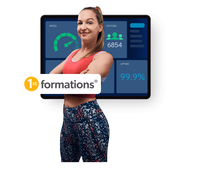 Woman standing next to a screen displaying high performance metrics, 1st formations logo in the foreground.
