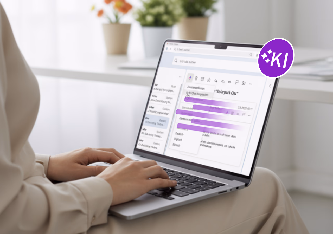 Eine Person sitzt am Laptop und verwendet eine E-Mail-Anwendung mit KI-Unterstützung.